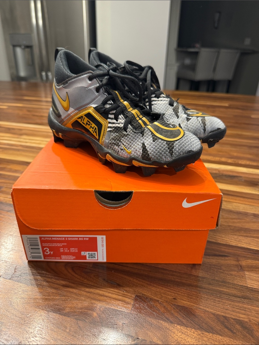 Nike Youth Alpha Menace Football Cleats — Black, Gray & Gold